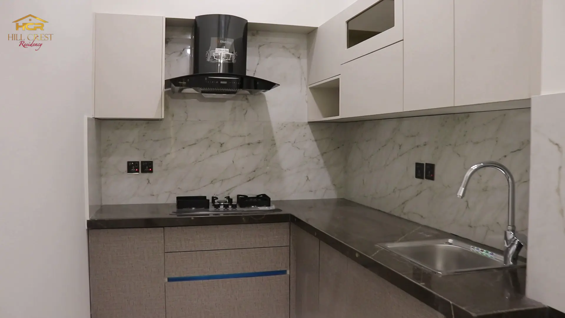 Hill Crest Residency modern kitchen with premium appliances and granite countertops